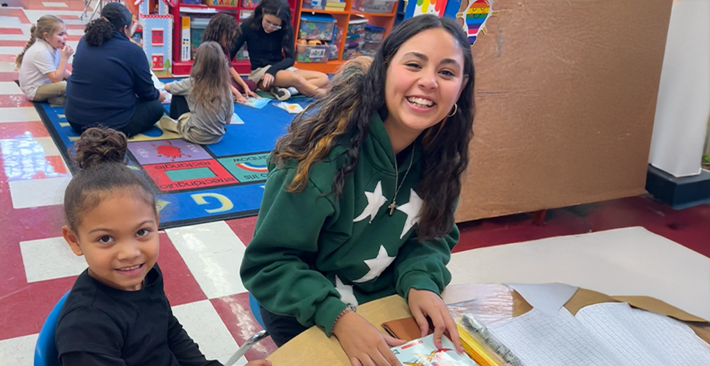 Middle school St. Anthony student reading to a pre-schooler<br />
